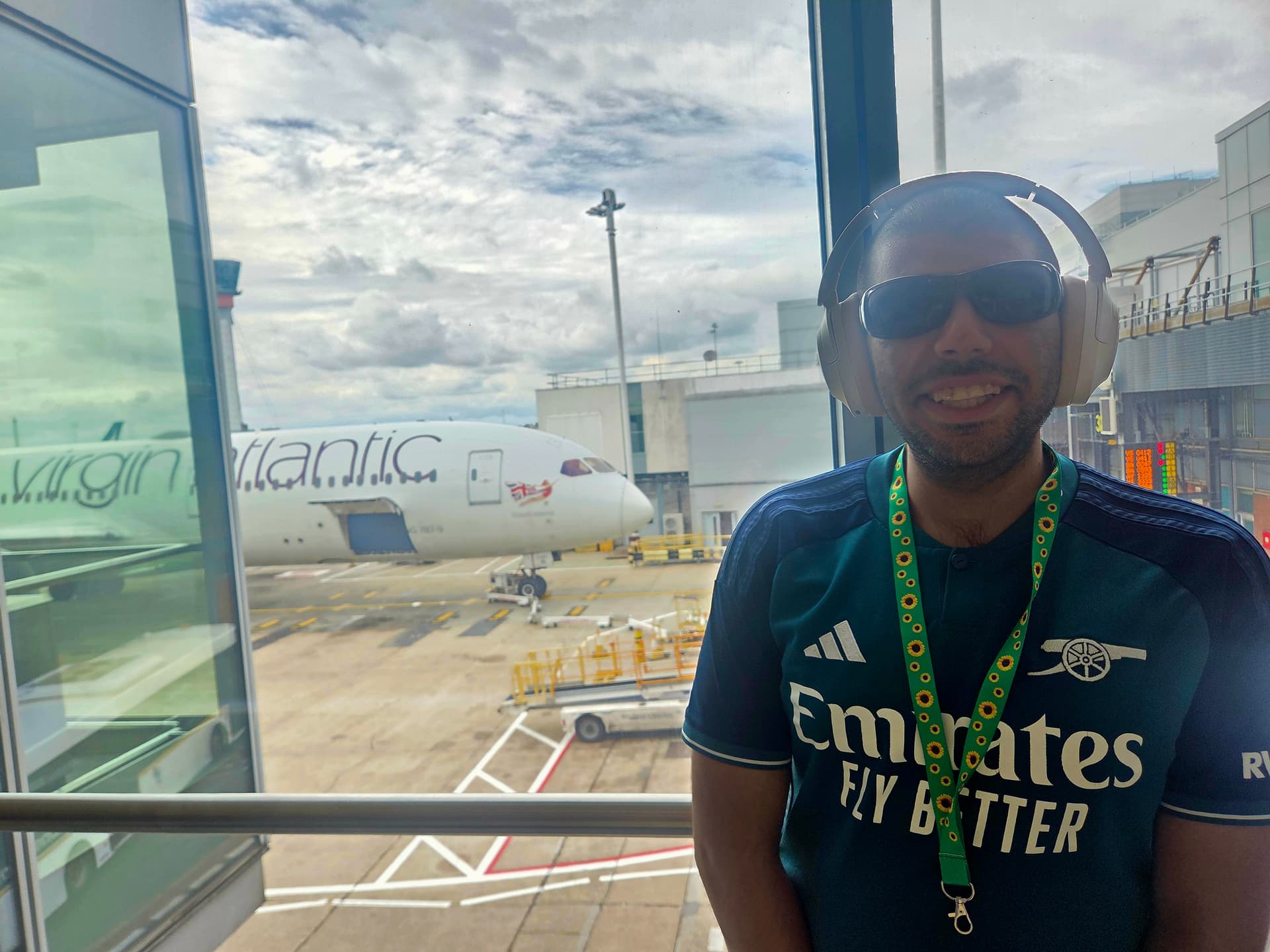 Danyal at the departure gate with a Virgin Atlantic plane