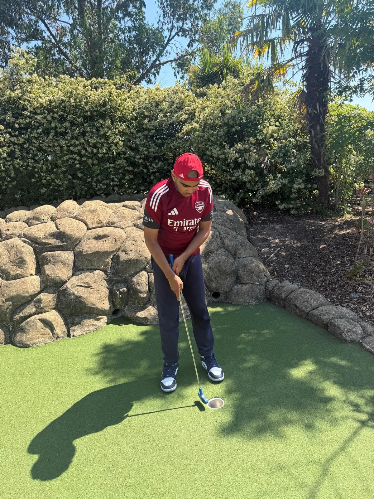 Danyal making a putt at crazy golf